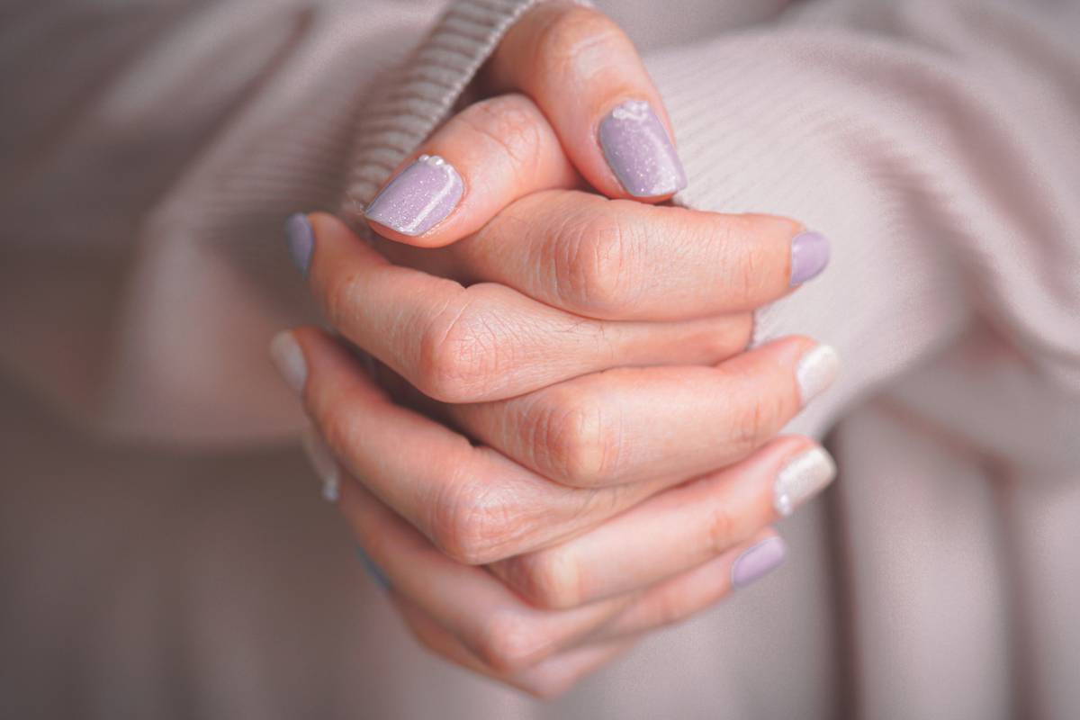 Before and after using nail fortifying coat showing stronger, less peeling natural nails