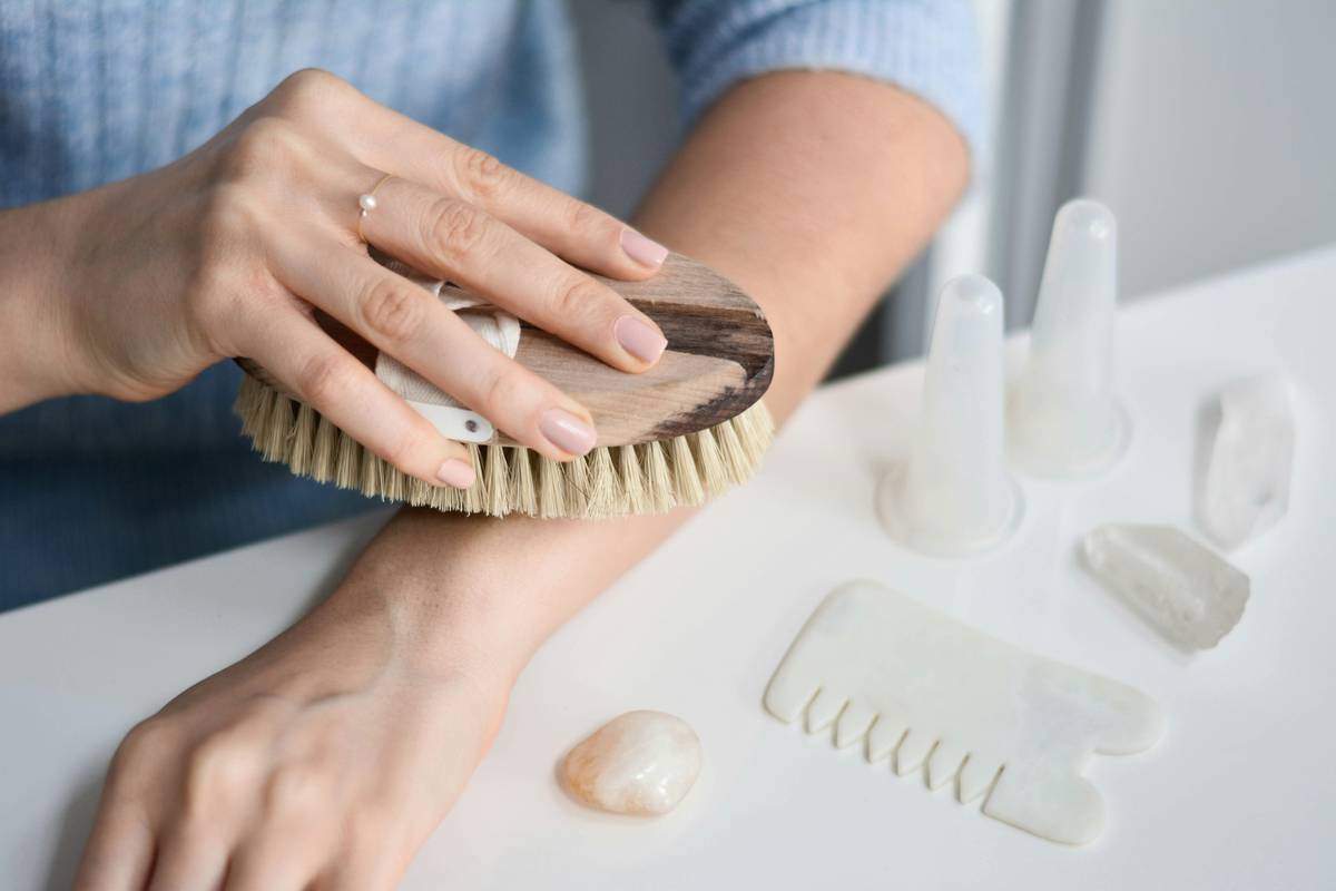 Woman applying base coat for manicure with precision brush technique
